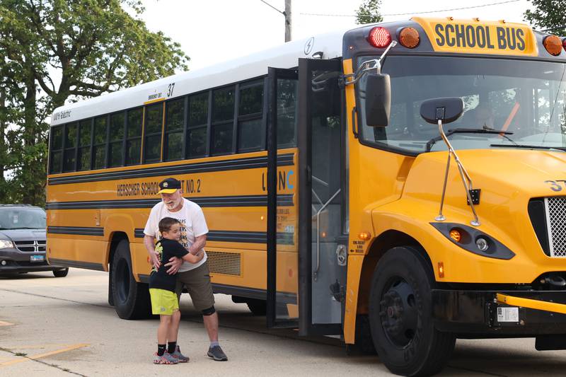 Herscher Intermediate School student Oakley Berns, 8, runs to hug his former bus aide, Mr. Russ Anderson, on the first day of school on Tuesday, Aug. 19, 2025.