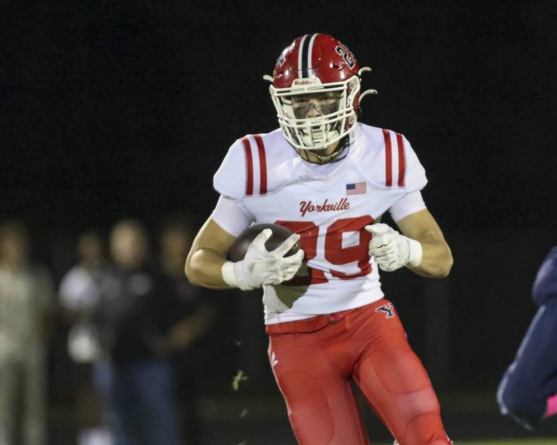 Yorkville's Jackson Knickerbocker (29) runs after a short catch during football game between Yorkville at Oswego East Friday, Oct 10, 2025 in Oswego.