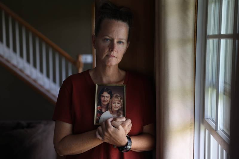 Brandy Butler holds her favorite photo of her and her bother Ed Butler. Ed, who recently passed, became a quadriplegic when his garage fell on him during the 1990 Plainfield tornado. Wednesday, Sept. 14, 2022.