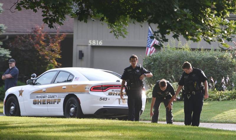 McHenry County sheriff's deputies search a grassy area near the scene of a shooting on the 5800 block of Wild Plum Road the morning of Wednesday, Aug. 9, 2023, near Crystal Lake.