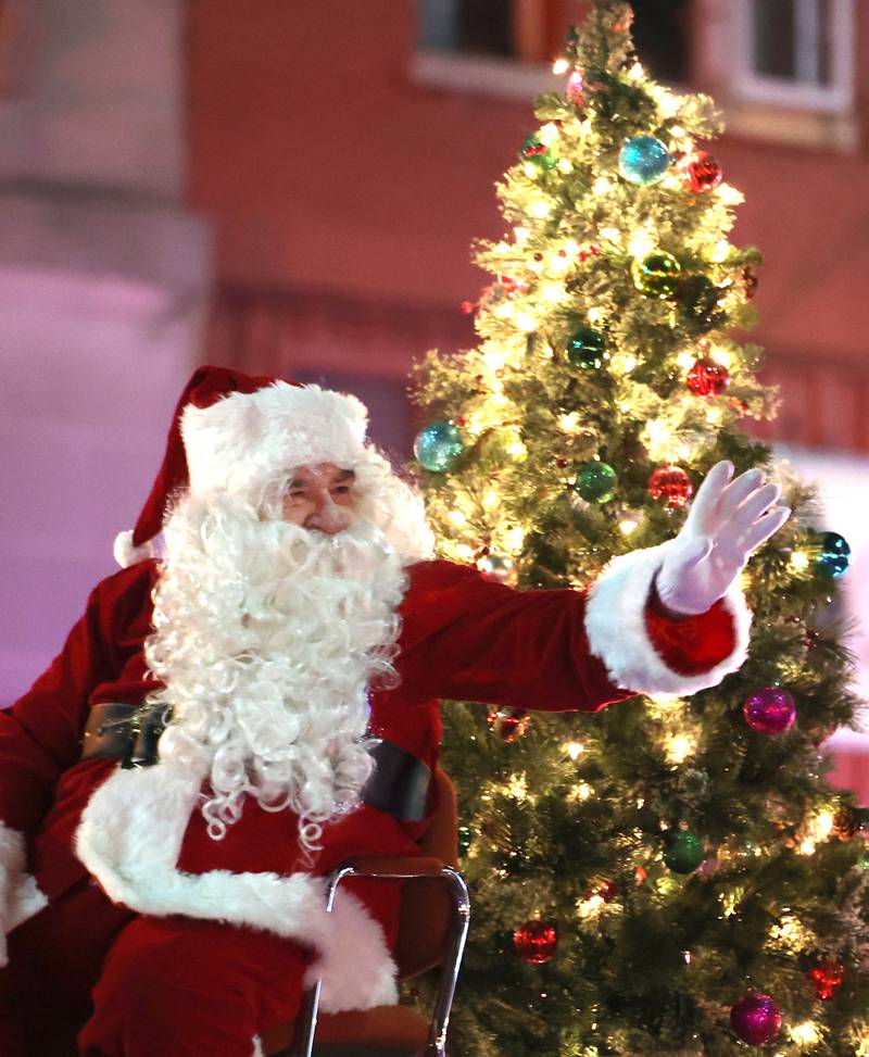 Santa waves at visitors as they drive down Lincoln Highway Thursday, Dec. 1, 2022, during the DeKalb Chamber of Commerce Lights on Lincoln and Santa Comes to Town.