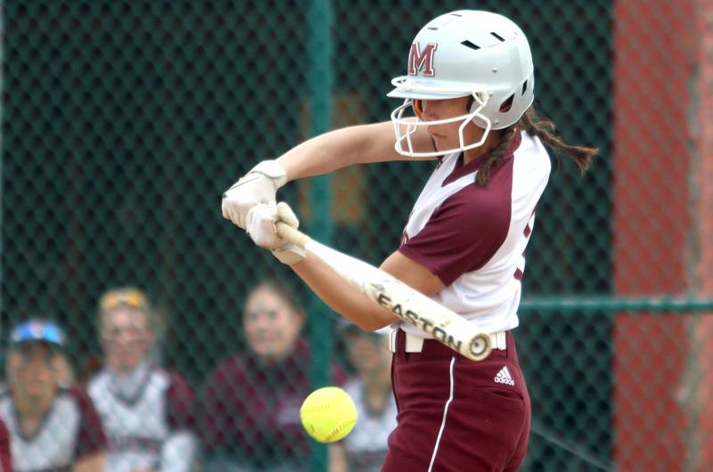 Marengo’s Marissa Young makes contact against Harvard in varsity softball at Marengo Thursday.