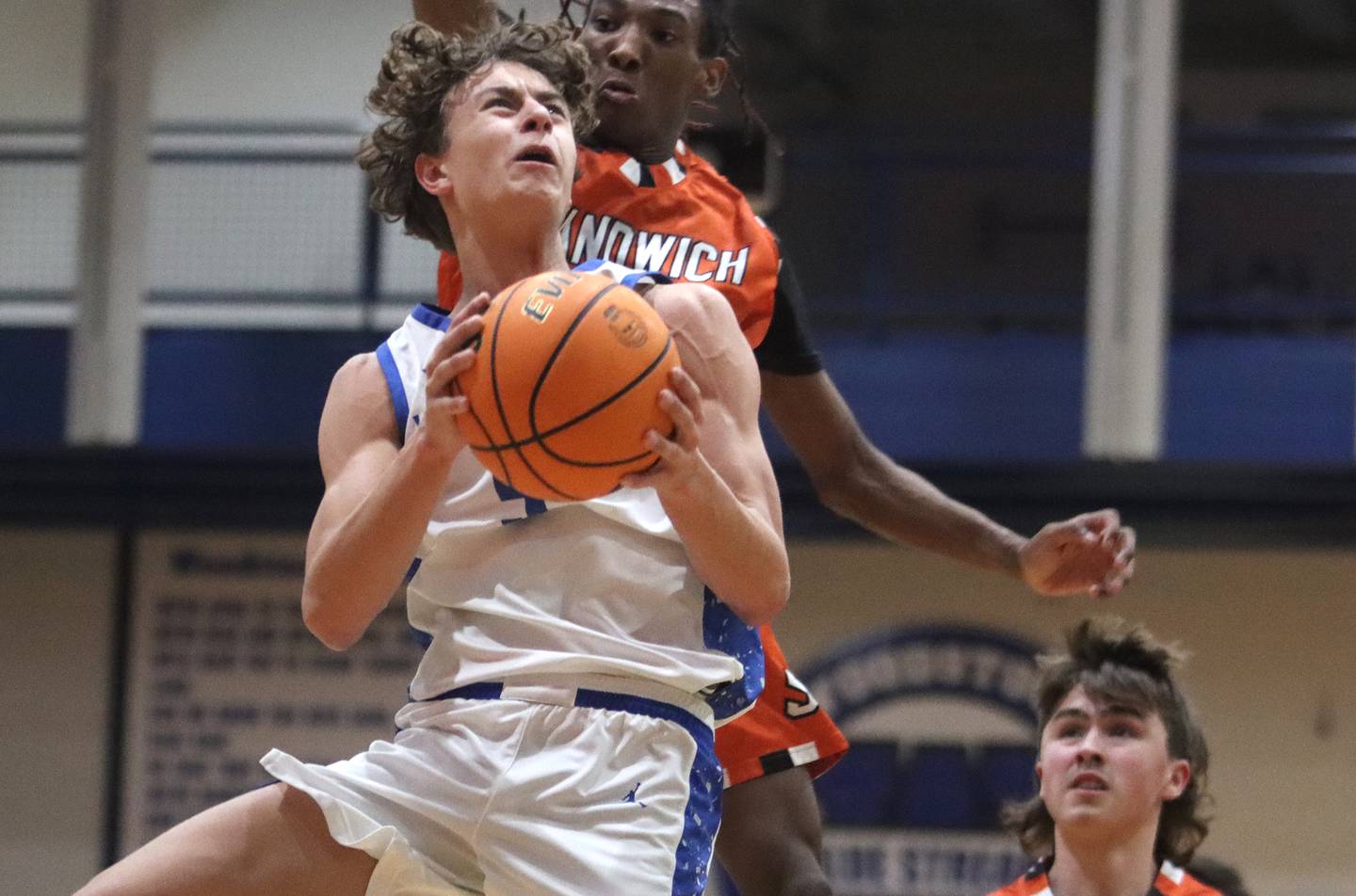 Woodstock’s Max Beard takes a shot as he is guarded by Sandwich’s EJ Treptow, back, in varsity boys basketball on Tuesday, Feb. 11, 2025, at  Woodstock High School in Woodstock.