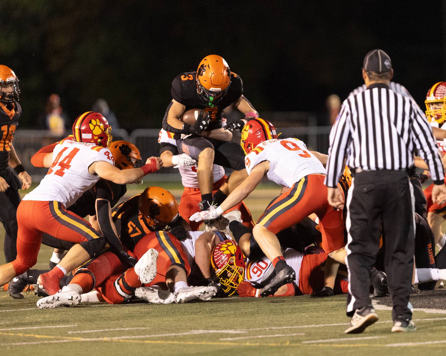 Wheaton Warrenville South's Owen Yorke tries to go over the Batavia defense on Friday, Oct. 24,2025 in Wheaton.