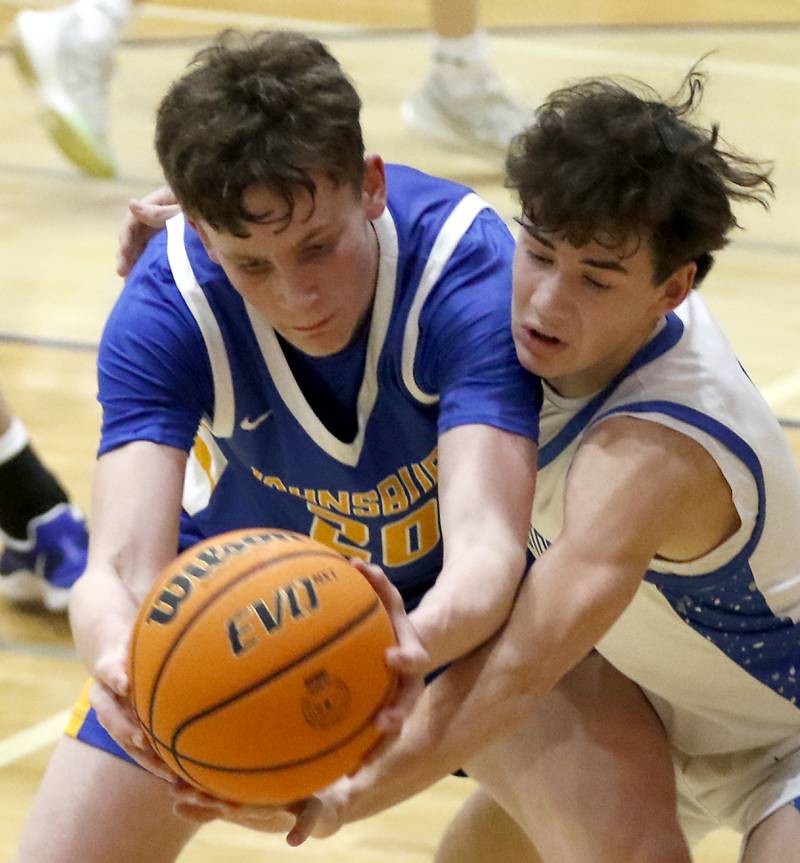 Johnsburg's Josh Kaunas tries to grab a pass as he is guarded by Woodstock's Collin Greenlee during a Kishwaukee River Conference basketball game on Friday,  Feb. 14, 2025, at Woodstock High School.