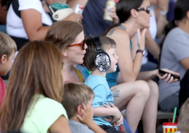 Emma Cole of Batavia and her son, Clark, 4, watch the demolition derby during the 155th Kane County Fair in St. Charles on Sunday, July 21, 2024.