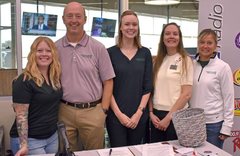 (From left) WALLS 102 Morning Show Host Dani Holland, poses with Hometown National Bank employees Dave Conterio, Madi Brown, Taylor Hish, and Tammy Humpage  during the Hometown National Bank “Hometown Hero” sweepstakes on Friday, Aug. 23, 2025 at Hy-Vee in Peru.