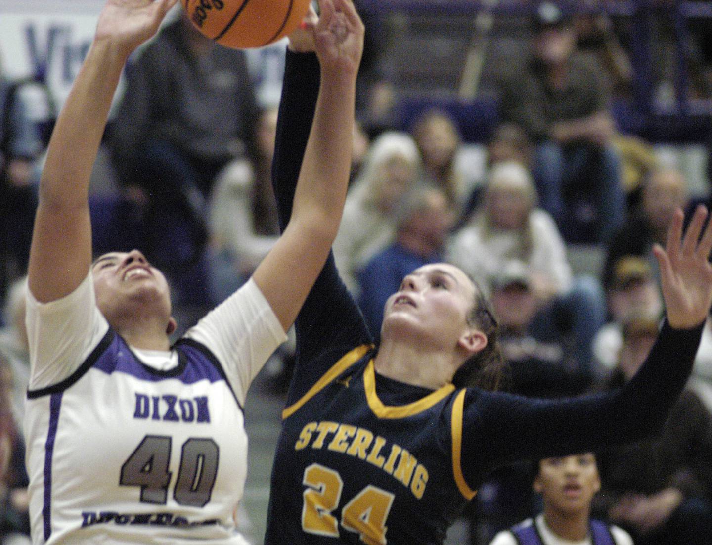 Dixon's Hallie Williamson and Sterlings Madison Austin battle for a rebound. Dixon and Sterling girls basketball teams played in the 3rd place game of the Dixon Girls KSB Holiday Basketball Classic Saturday, Dec. 28, 2024.
