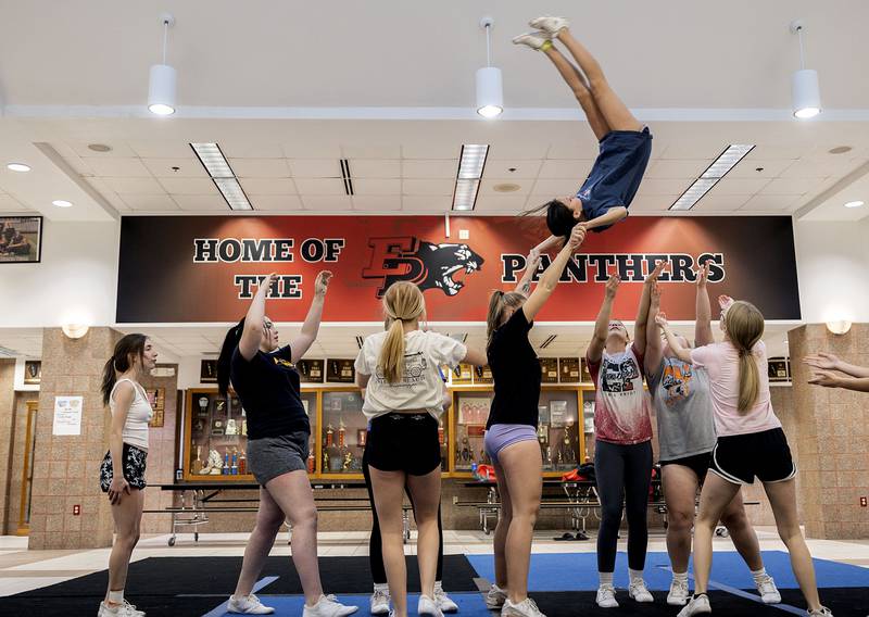 High-flying Nevaeh McElhiney goes head over heals while practicing a stunt for the competitive cheerleading sectional on Wednesday, Jan. 18, 2023 at Erie High School.
