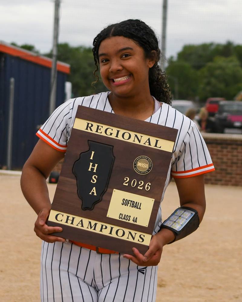 Oswego's Jaelynn Anthony (20) is all smiles and poses with the regional plaque after taking the win over Benet Academy on Friday May 22, 2026, held at Oswego High School.