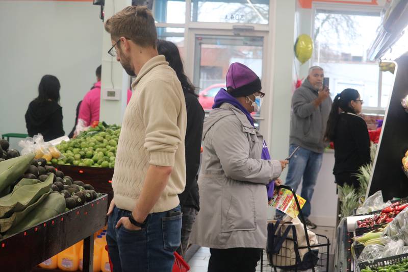 Customers browse the fresh veggie section at DeKalb Fresh Market, 304 N. Sixth St., DeKalb, during the store's grand opening on Tuesday, Nov. 21, 2023.