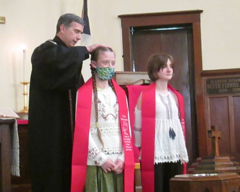 Pictured are  United Methodist Church of Plano confirmands Sera and Lynze with Pastor Steve after receiving their confirmation stoles.