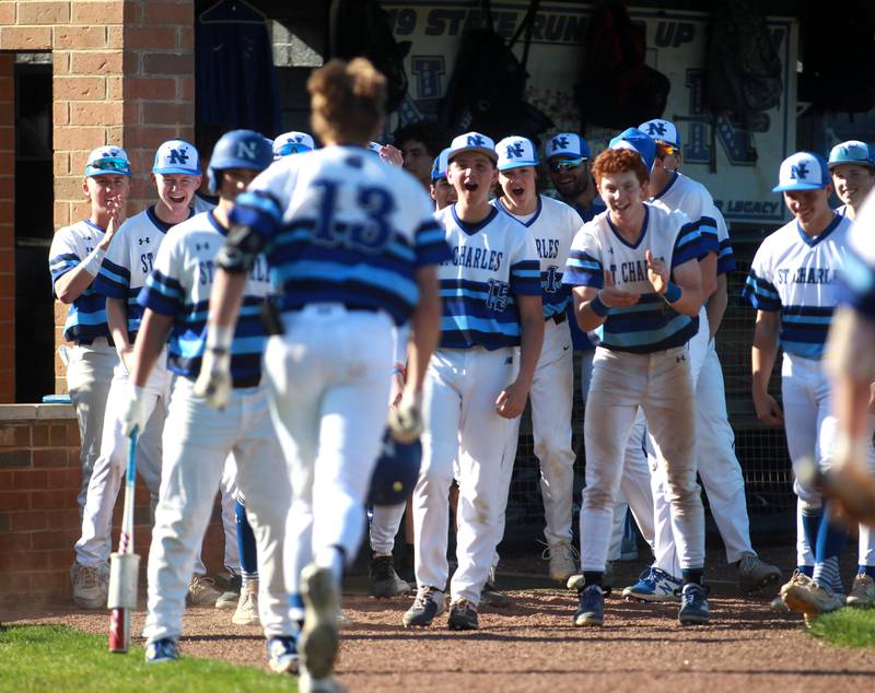 St. Charles North players celebrate Parker Reinke’s home run during a game against Batavia at St. Charles North on Monday, April 15, 2024.