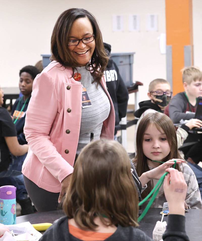 Treveda Redmond, principal at Huntley Middle School, has a laugh with sixth-grade students during lunch Tuesday, March 14, 2023, at the school in DeKalb.