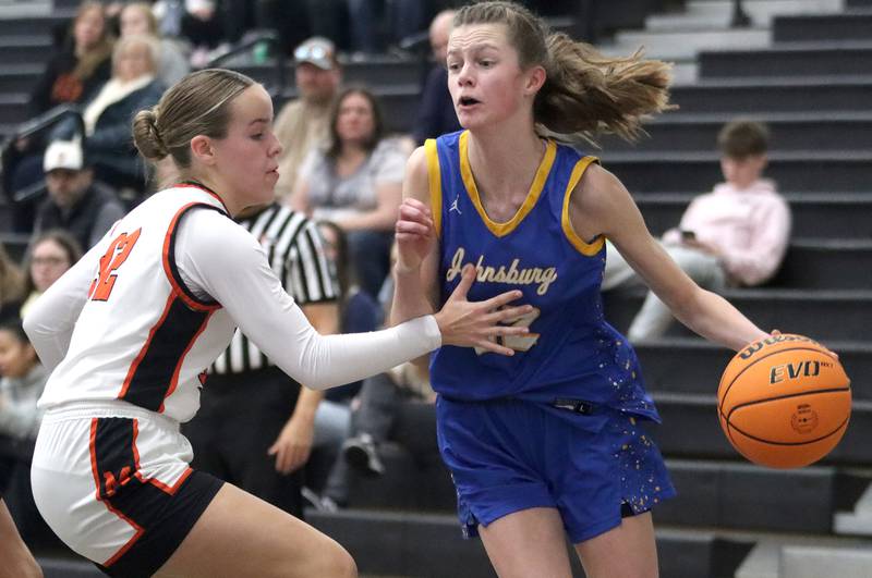 McHenry’s Lucy Jones, left, guards Johnsburg’s Skye Toussaint in varsity girls basketball on Saturday, Jan. 4, 2025, at McHenry High School in McHenry.