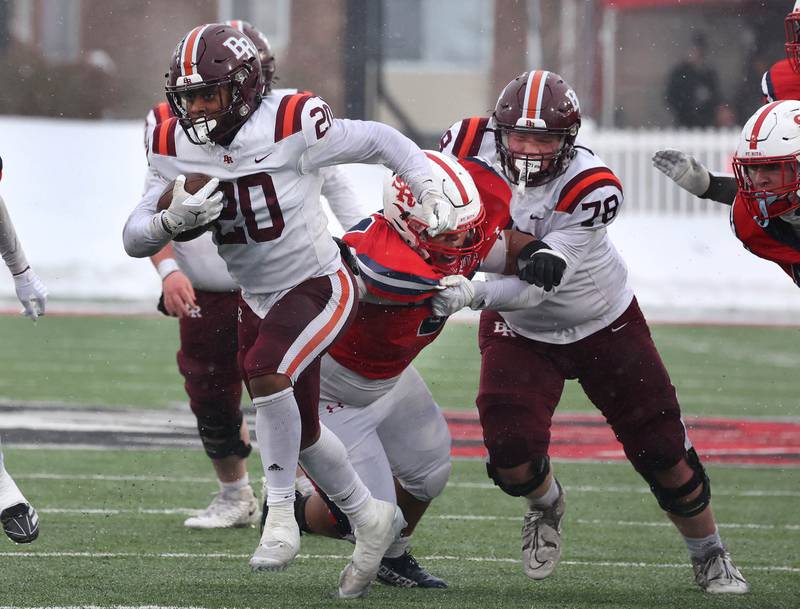 Brother Rice's Jaylin Green finds a hole in the St. Rita defensive line Wednesday, Dec. 3, 2025, during their IHSA Class 7A state chamionship game in Huskie Stadium at Northern Illinois University in DeKalb.