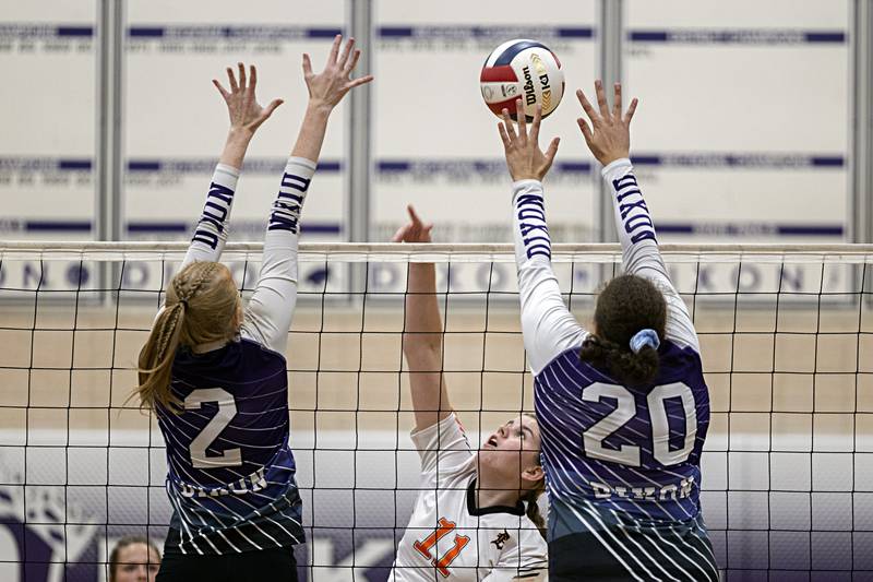DeKalb’s Camryn Hilliard works the net against Dixon’s Madyson Tichler and Olivia Cox Tuesday, Sept. 5, 2023 in a game at Dixon High School.