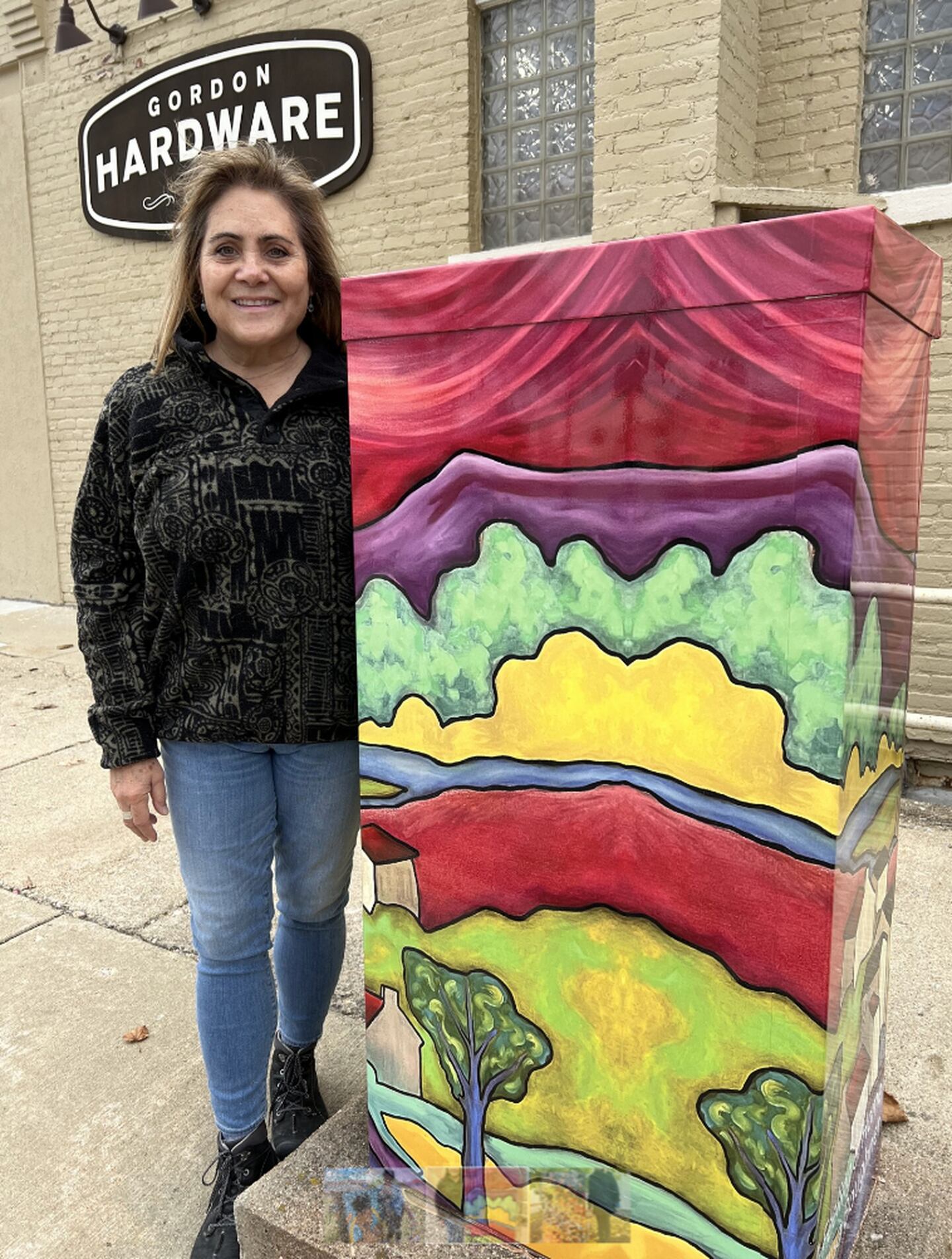 The utility box mural on South Fifth Street in DeKalb was created using a painting by artist Elisa Boughner.