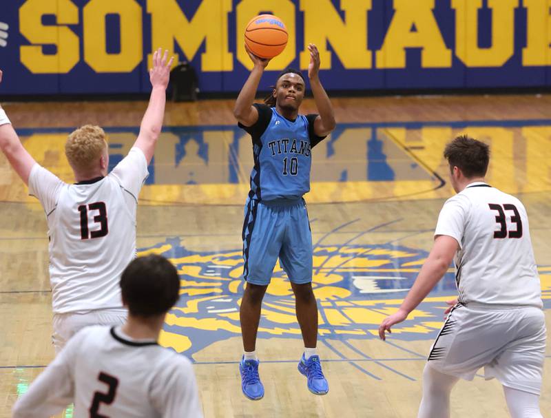 IMSA’s Benjamin Dixson shoots the ball between Indian Creek's Isaac Willis (left) and Payton Hueber Friday, Feb. 6, 2026, during their Little 10 Conference championship game at Somonauk High School.