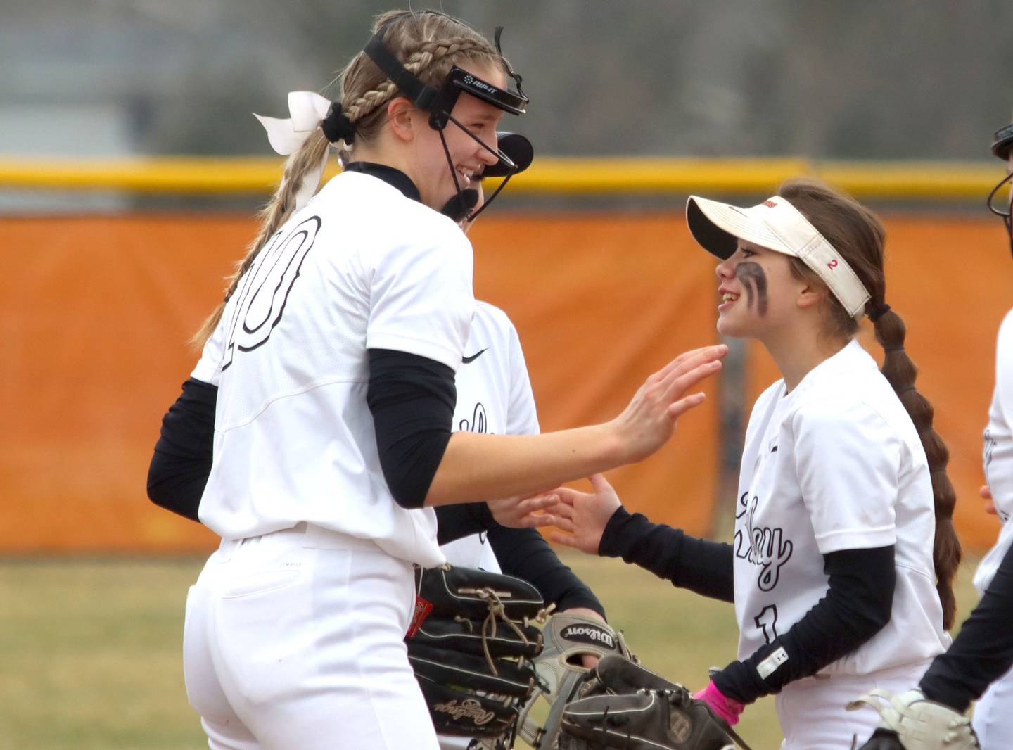 Huntley’s Jori Heard, left, and Sadie Svedsen, share a laugh between innings during a game against McHenry on April 5, 2022.
