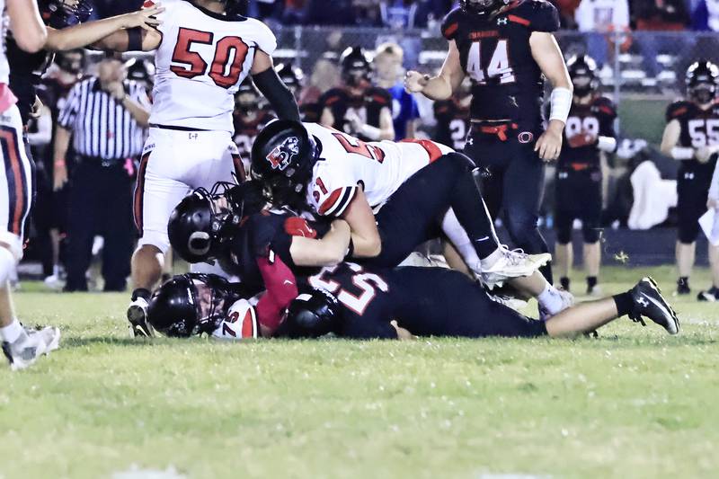 Orion quarterback #2 Kale Filler was sandwiched between Erie-Prophetstown Panther’s #51 Derek Naftzger and #75 Caleb Reymer Friday, Oct. 10, 2025, in Orion. The Chargers were no match for the visiting Panthers, losing 40-14