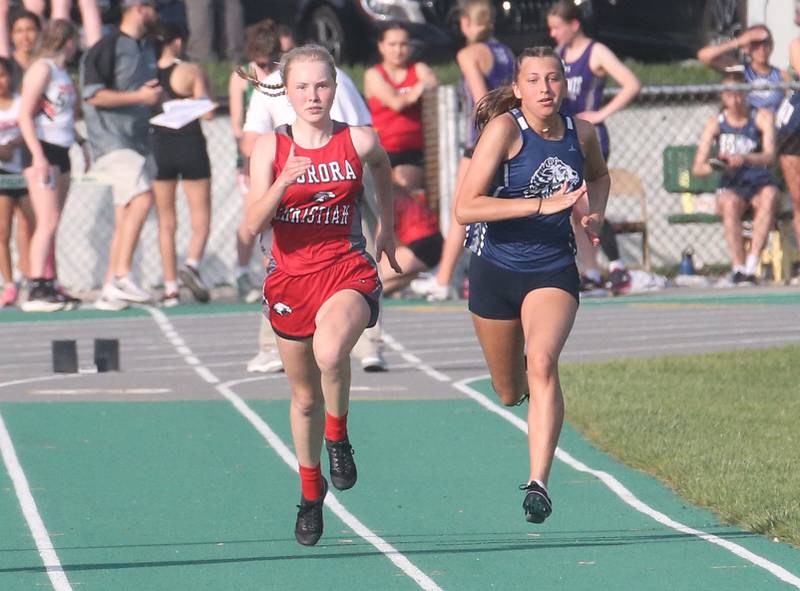 Aurora Christian's Grace Knight and Lisle's Alexa Walker compete in the 100 meter dash during the Class 1A Sectional track meet on Thursday, May 15, 2025 at Seneca High School.