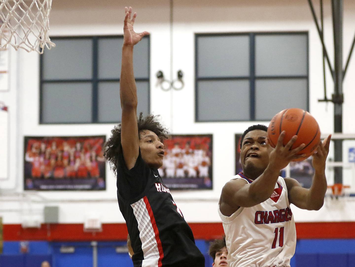 Dundee-Crown's Terrion Spencer drives to the basket against Huntley's Omare Segarra during a Fox Valley Conference boys basketball game Tuesday, Feb. 14, 2023, at Dundee-Crown High School in Carpentersville.