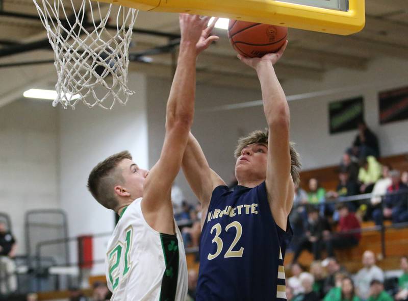 Marquette's Charlie Mullen posts up in the lane to shoot a shot over Seneca's Lane Provance during the Tri-County conference Championship game on Friday, Jan. 27, 2023 at Putnam County High School.