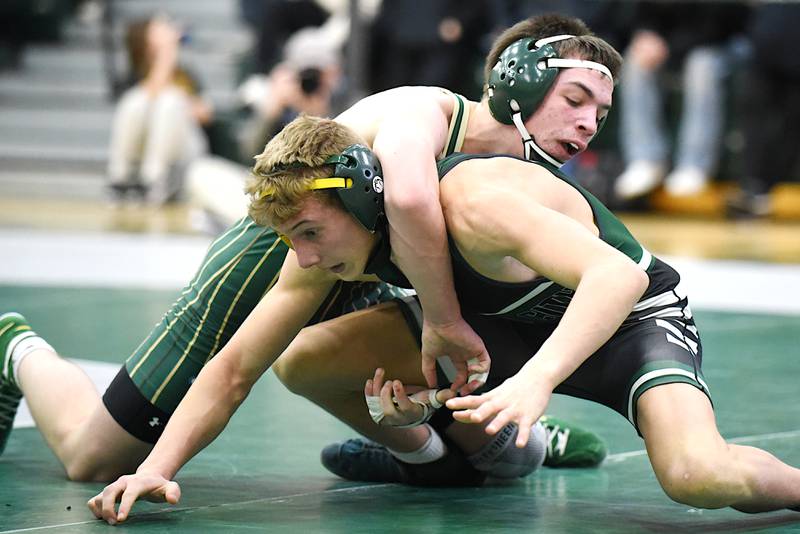 Coal City's Luke Munsterman, left, tries escaping the grasp of Bishop McNamara's Blake Arseneau during the 132-pound third-place match at the IHSA Class 1A Coal City Sectional Saturday, Feb. 15, 2025.