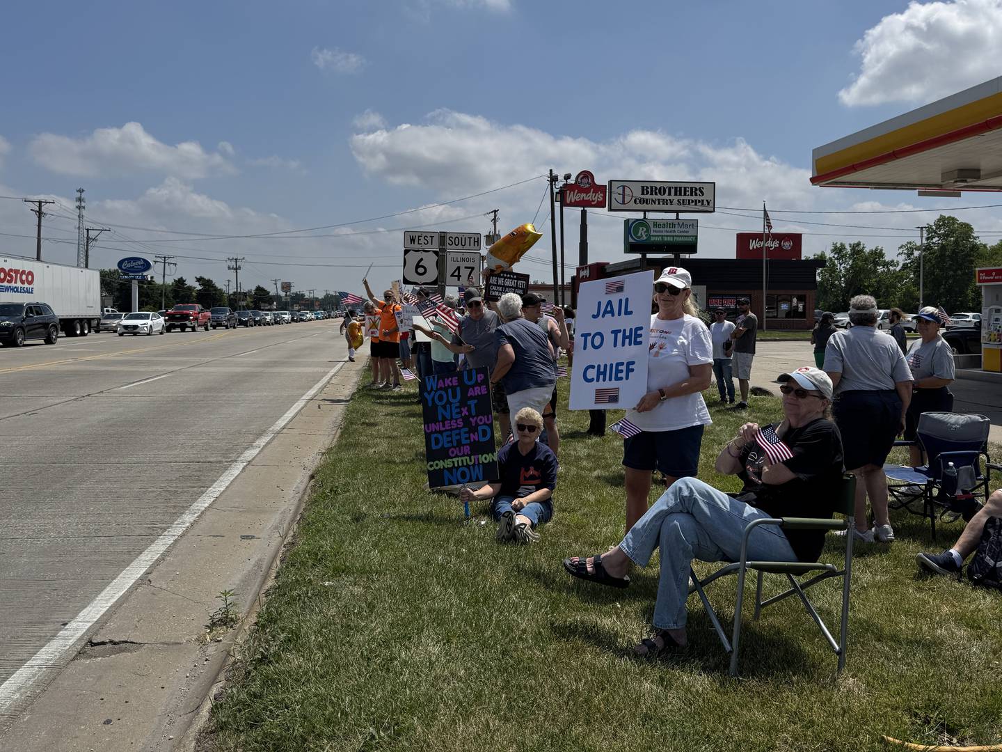 Protesters line up along the junction of US Route 6 and Illinois Route 47 for the No Kings Day protest in Morris on Saturday, June 14, 2025.