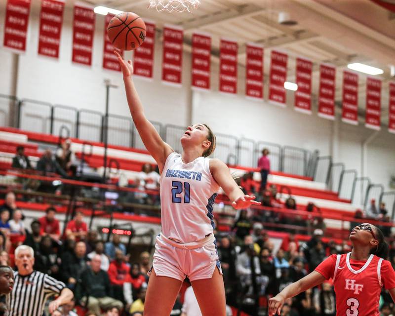 Nazareth's Olivia Austin (21) puts in a lay up during Class 4A girls supersectional basketball game between Homewood-Flossmoor at Nazareth. Feb 26, 2024.
