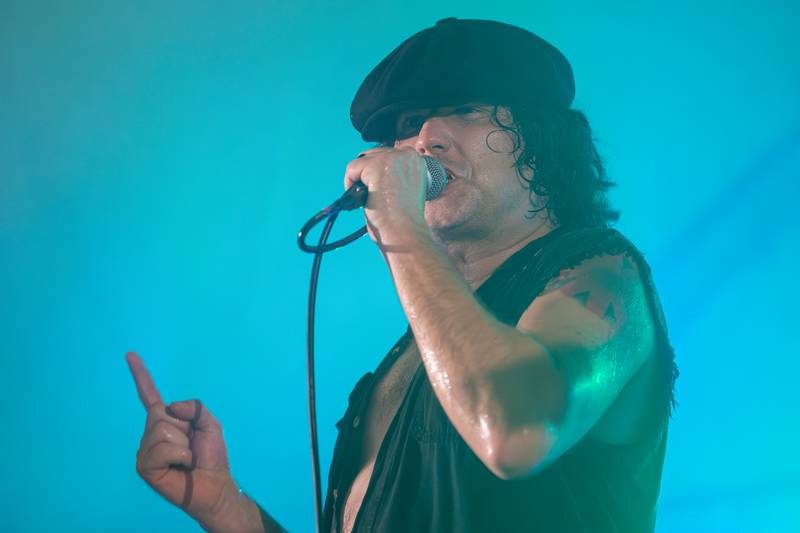 Bobby Lee Stamper of Thunderstruck sings into the microphone during a performance at the annual Cops for Cancer event on Friday, July 25, 2025, at Cerri Memorial Park in Cedar Point.