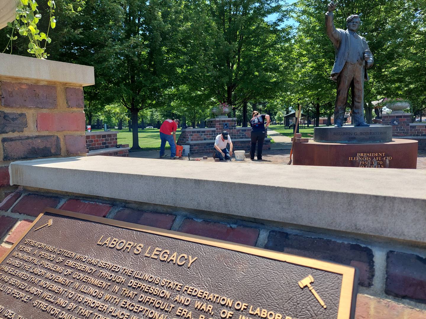 Volunteers from Laborers Local 393 work on maintenance at the Reuben Soderstrom Plaza in Streator. Soderstrom was a leading figure in labor from the Great Depression to the Civil Rights movement.