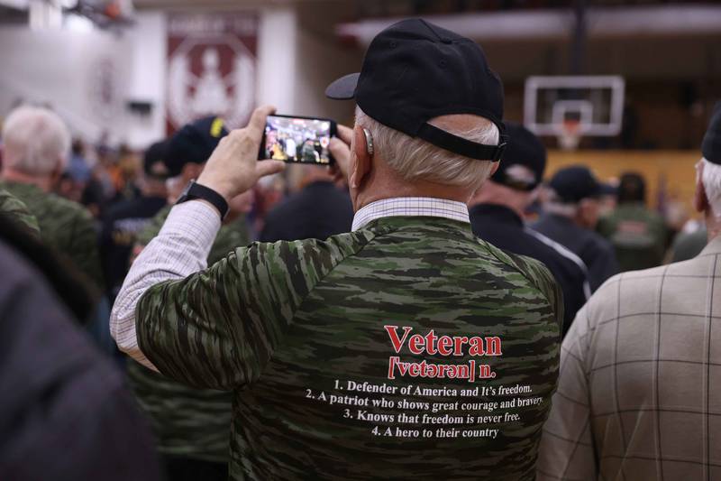 A veteran takes video of the Lockport Township High School 10th Annual Veterans Night Celebration on Friday, Dec. 6, 2024.