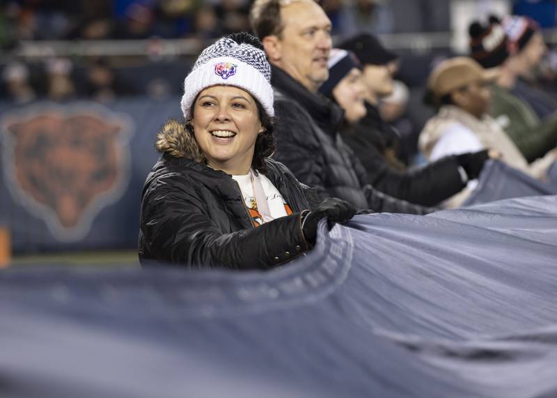 Advocate Health Care cancer survivor Sally Wagner was recognized as the Chicago Bears’ special guest Dec. 26 during the Bear Down Flag Ceremony. Here she is waving the flag on the field.