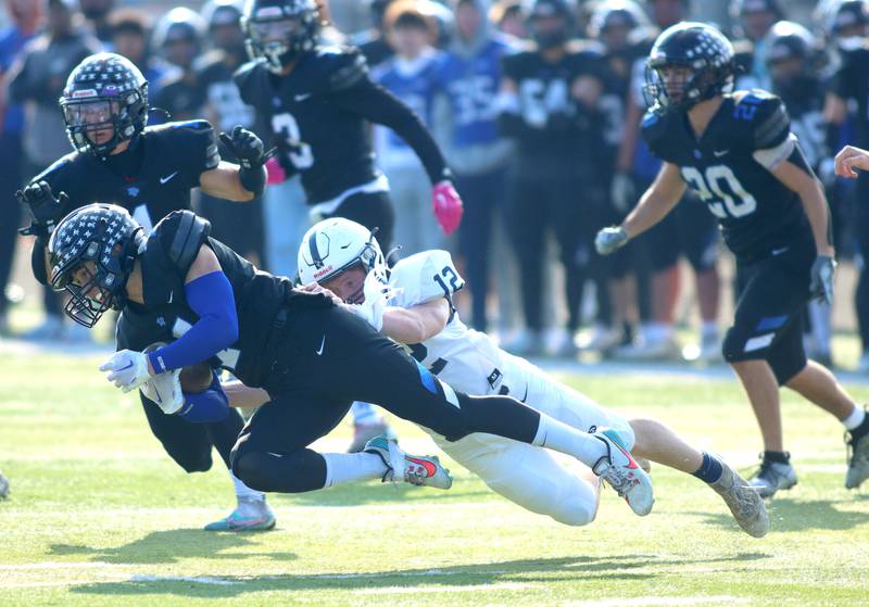 Cary-Grove’s Michael Dunkin, right, chases down Highland Park’s John Walker in second-round IHSA Class 6A playoff action at Wolters Field in Highland Park Saturday.