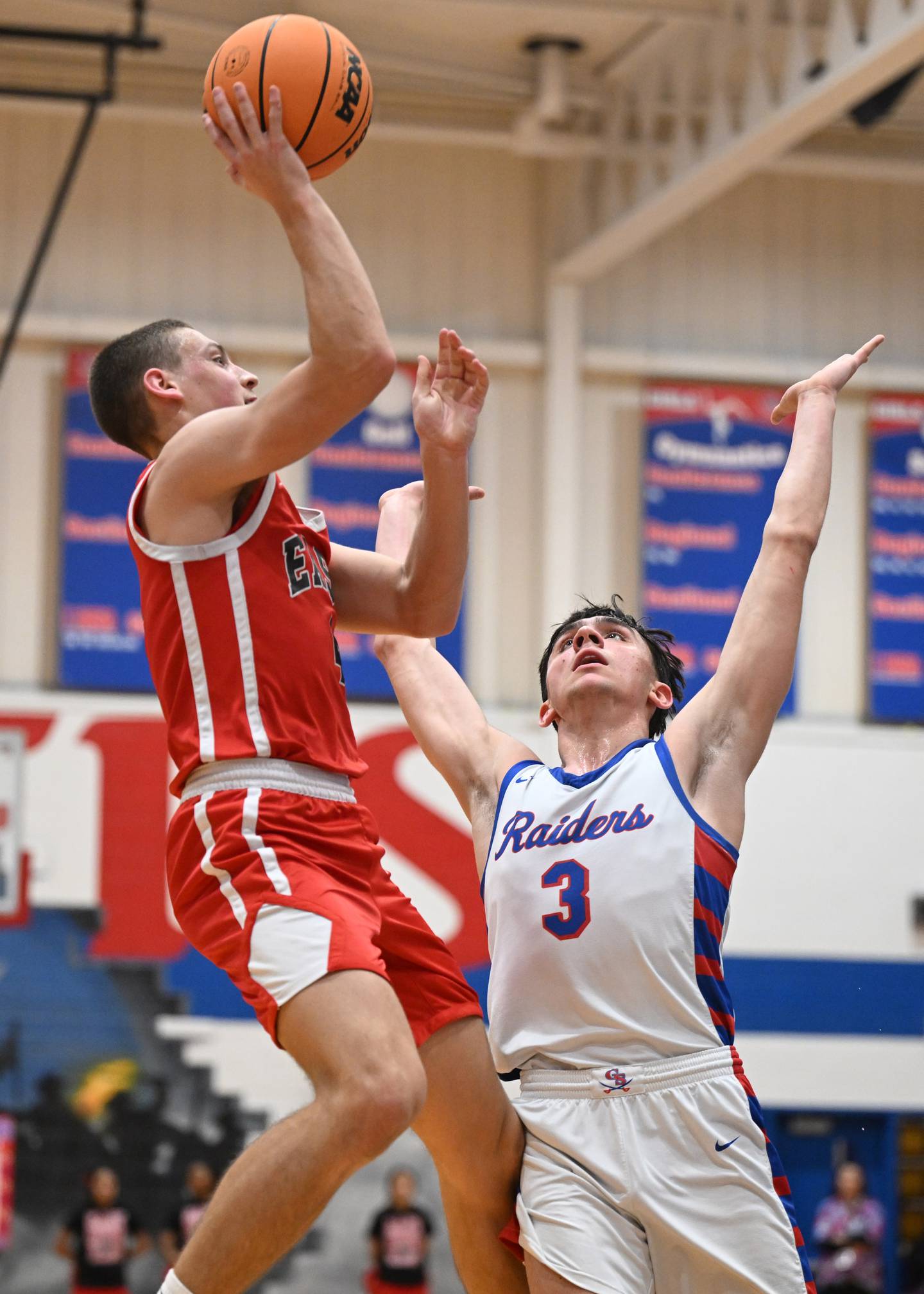 Glenbard East's Michael Nee, left, shoots against the defense of Glenbard South's Sean Reese during Friday’s game in Glen Ellyn.