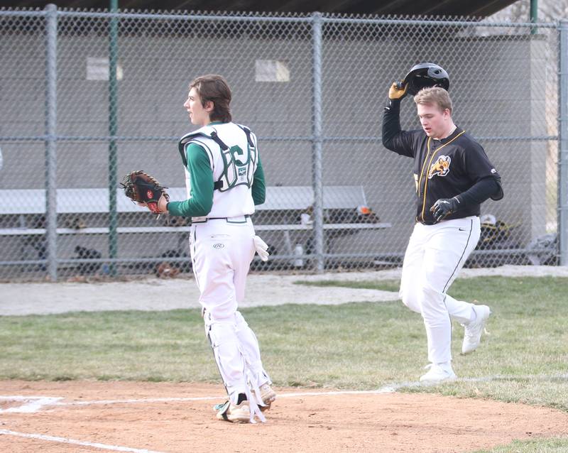 Riverdale's Dawson Peterson runs to home plate after hitting a home run against St. Bede as St. Bede's catcher Nathan Husser backs away on Monday, March 20, 2023 at St. Bede Academy.