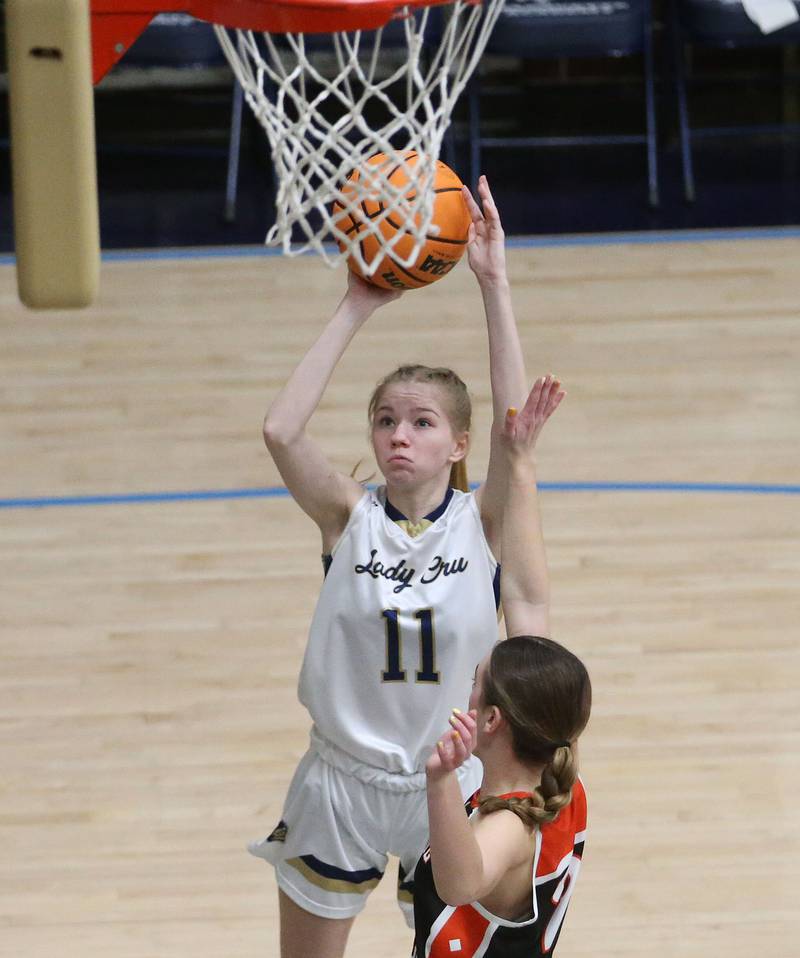 Marquette's Keely Nelson takes a jump shot near the hoop over Roanoke-Benson's Elly Heineke on Thursday, Feb. 6, 2025 in Bader Gym at Marquette High School.