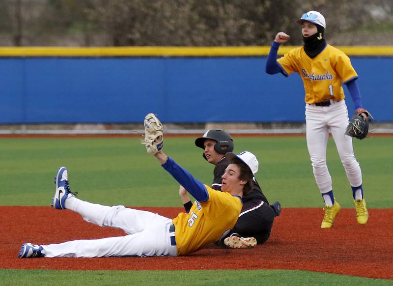 Johnsburg's Ahston Stern and Tayden Pinkowski celebrate taking out Marengo's Alten Bergbreiter to end  Marengo two run seventh inning during a Kishwaukee River Conference baseball game on Monday, April 21, 2025, at Johnsburg High School.