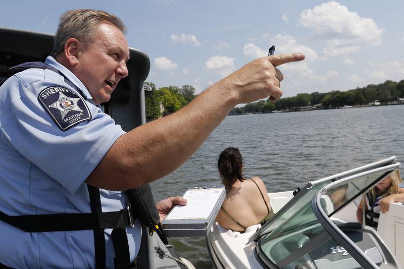 McHenry County Sheriffs Office Marine Unit Deputy John Szatkowski performs a safety inspection for boaters on the Fox River and Chain O' Lakes on Tuesday, July 6, 2021.