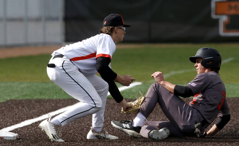 McHenry’s Kaden Wasniewski tags out Crystal Lake Central's James Dreher as he tries to steal third base during a Fox Valley Conference baseball game on Friday, May 2, 2025, at McHenry High School.