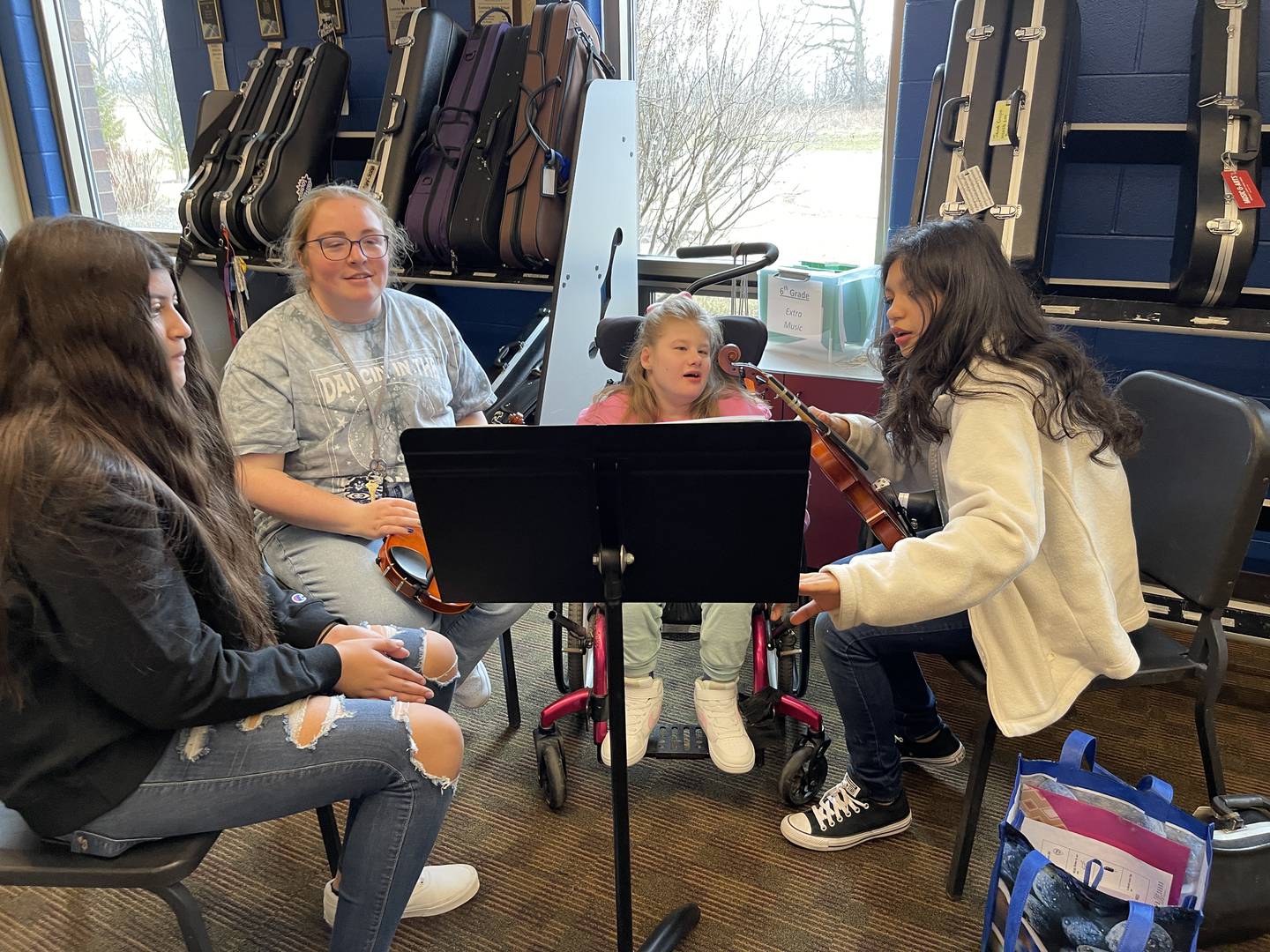 From left to right, Laila Arias, classroom associate Gretchen Butenschoen, Olivia Hagen and Yaxiri Juarez-Ramos practice music on Friday, Jan. 13, 2023, at Creekside Middle School, as part of the United Sound program. United Sound is geared toward removing social barriers through music. At Creekside, it provides students in special education the opportunity to learn how to play while receiving social interaction.