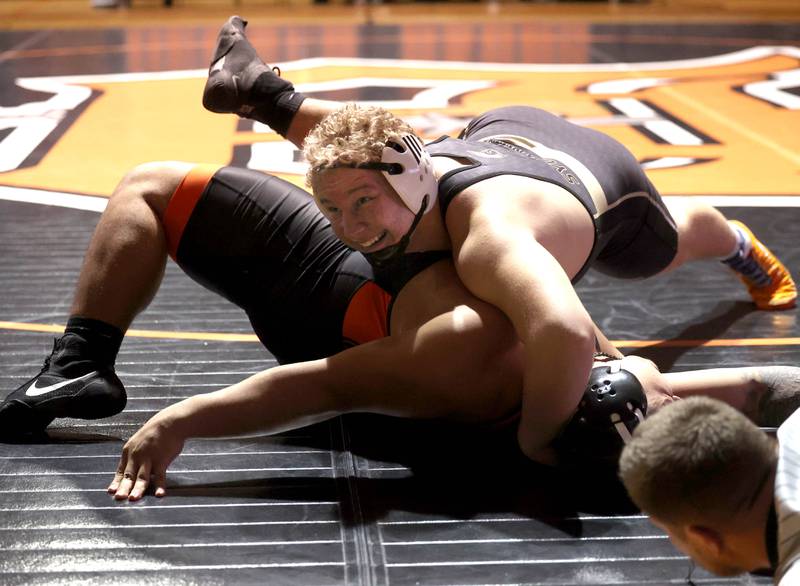 Sycamore’s Collin Hughes pins DeKalb’s Jeremiah Pineira Friday, Jan. 17, 2025, during their 285 pound match at DeKalb High School.