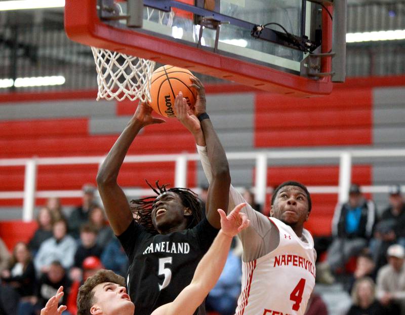 Kaneland's Freddy Hassan (left) grabs a rebound away from Naperville Central's Evan Moss during a game on Tuesday, Jan. 14, 2025 in Naperville.