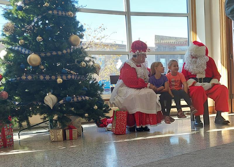 Children visit Saturday, Nov. 18, 2023, with Santa Claus and Mrs. Claus during the Christmas Walk at the Prouty Building in Princeton.