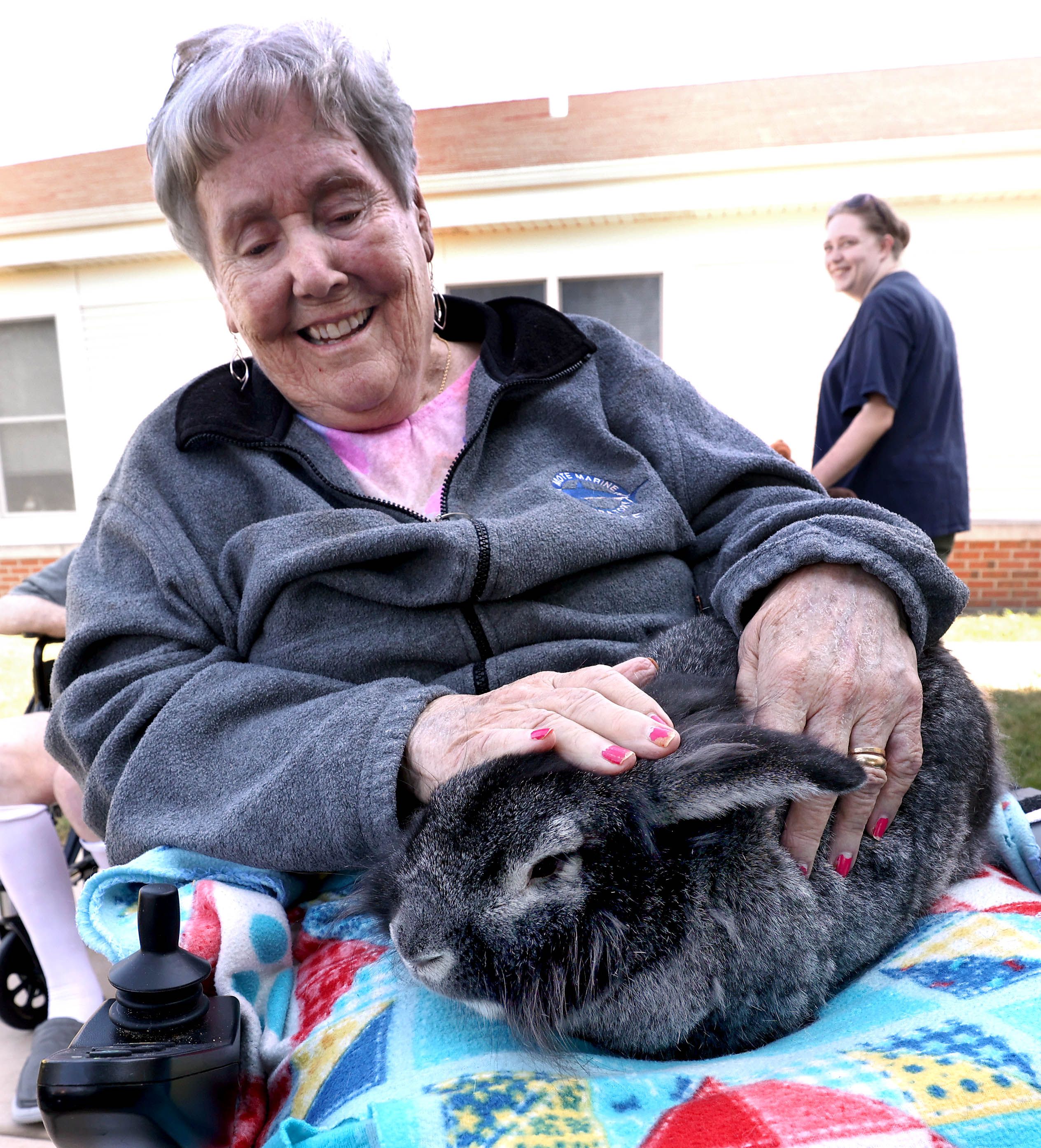 DeKalb County Rehab and Nursing Center resident Carol Janetezke pets a rabbit during a visit from Kate’s Kritters Mobile Petting Zoo Thursday, Sept. 18, 2025, at the facility in DeKalb.
