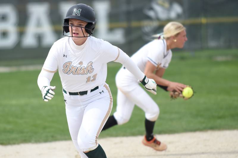 Bishop McNamara's Emma Thyfault runs to third base as St. Laurence's Demi Lotus fields a ground ball in the background during a game at Bishop McNamara Saturday, April 11, 2026.