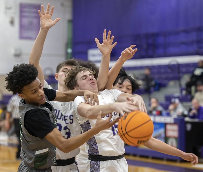 Dixon and Plainfield Central players battle for a ball Friday, Jan. 3, 2025, at Dixon High School.