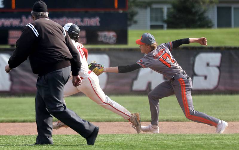 McHenry's Landon Clements tags out Huntley's Diego Herrera after a base running error during a Fox Valley Conference baseball game on Tuesday, May 8, 2026, at Huntley High School.